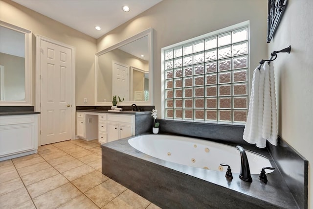 bathroom with vanity, a bath, and tile patterned floors