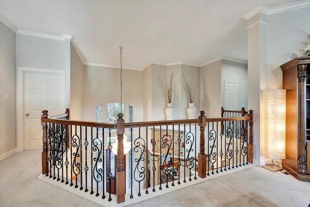 hallway featuring crown molding, a notable chandelier, and light carpet