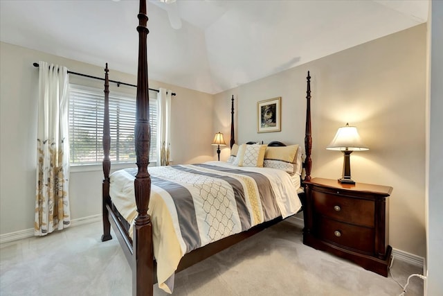 bedroom with vaulted ceiling and light carpet