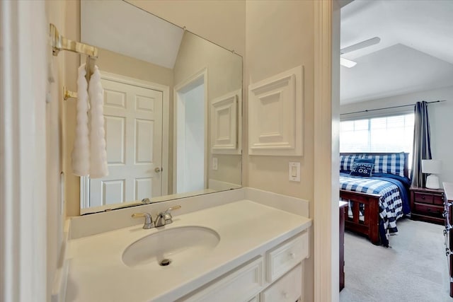 bathroom featuring vaulted ceiling and vanity