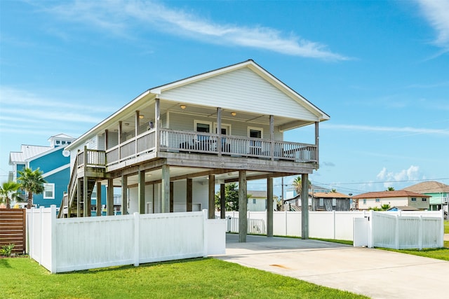 rear view of property with a porch and a lawn