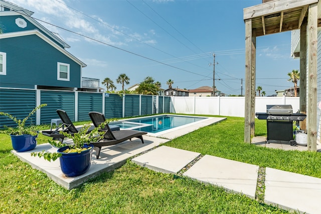 view of swimming pool featuring a yard, a patio area, and a grill