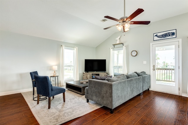 living room with dark wood-type flooring, ceiling fan, and vaulted ceiling