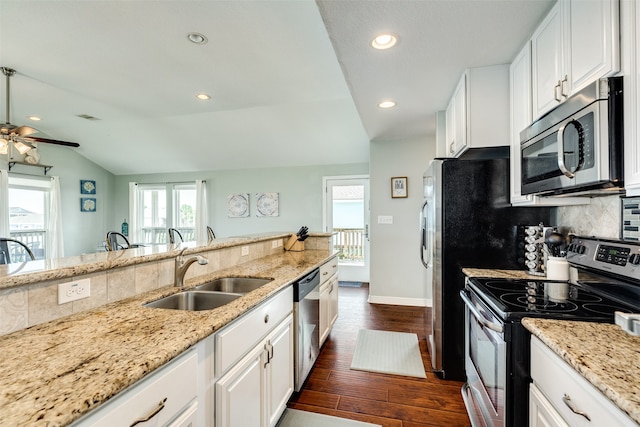 kitchen featuring stainless steel appliances, white cabinetry, sink, lofted ceiling, and dark wood-type flooring