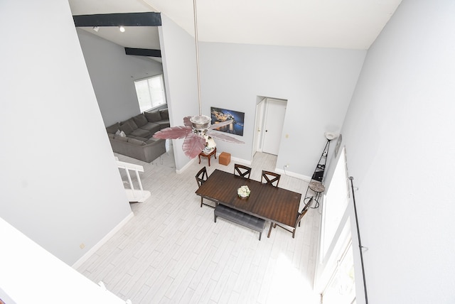 living room with light hardwood / wood-style flooring and high vaulted ceiling