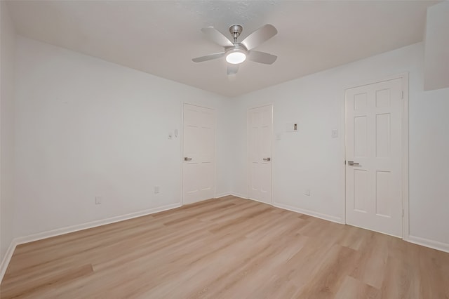 spare room featuring light hardwood / wood-style flooring and ceiling fan