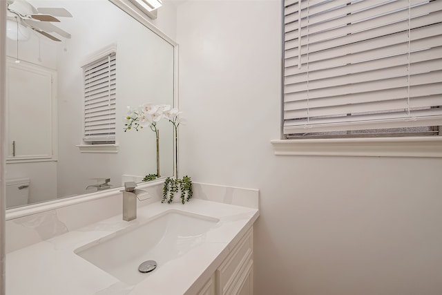 bathroom featuring ceiling fan and vanity