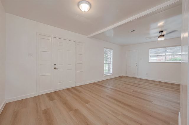 interior space featuring light wood-type flooring, ceiling fan, and a closet