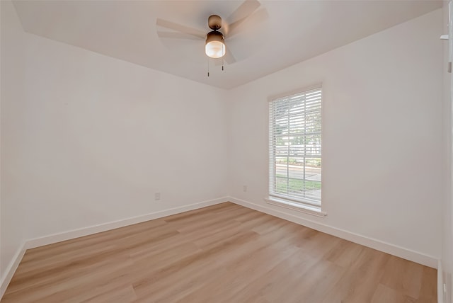 spare room featuring light hardwood / wood-style floors and ceiling fan