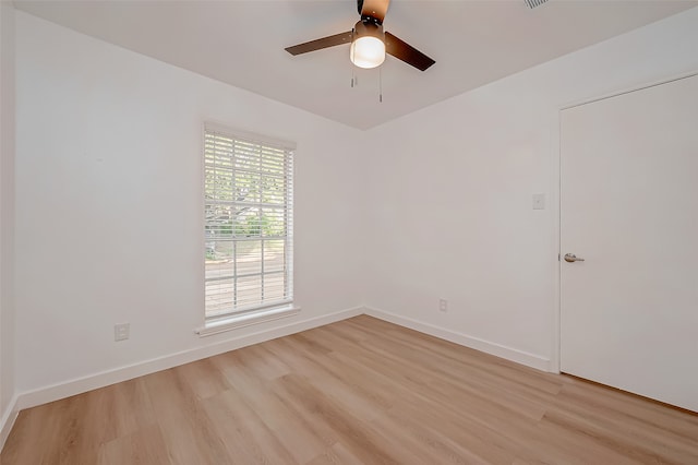 spare room with light wood-type flooring and ceiling fan