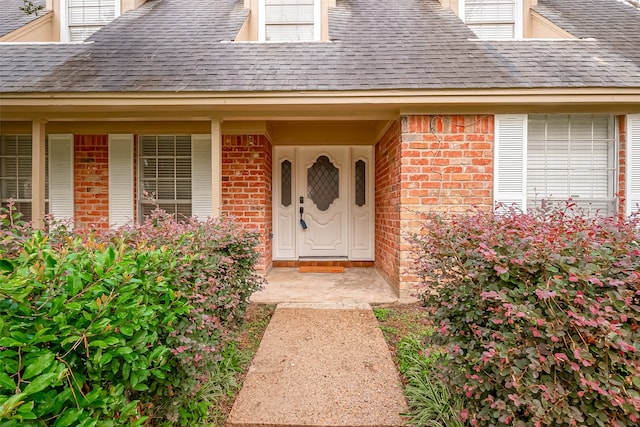 view of exterior entry with covered porch