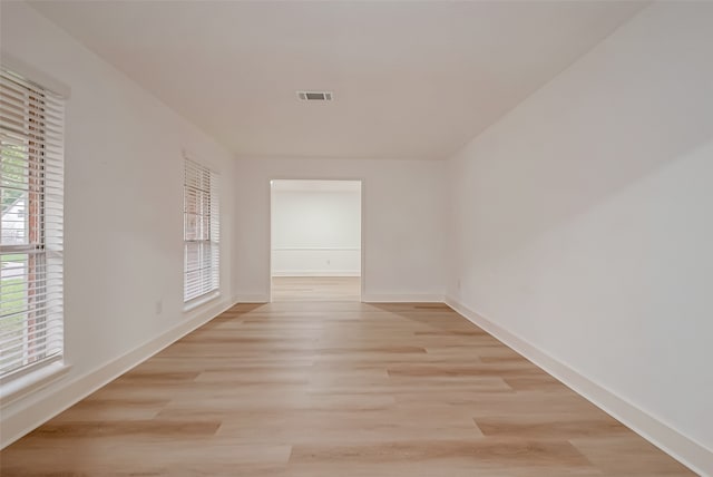 empty room with light hardwood / wood-style flooring