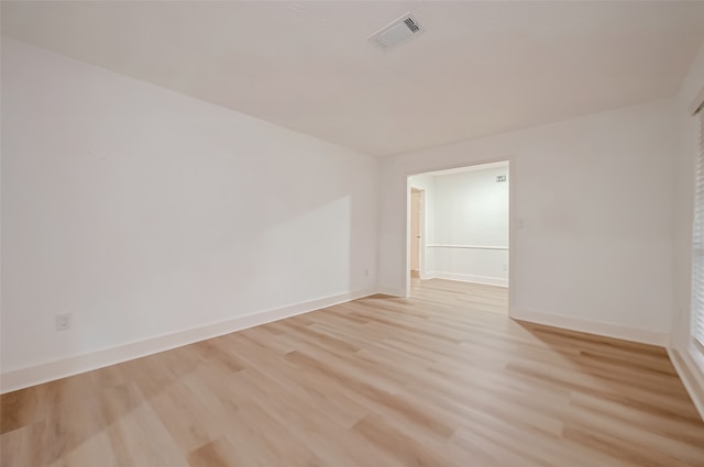 unfurnished room with light wood-type flooring