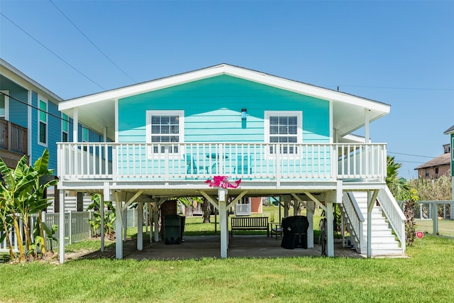 rear view of property featuring a yard and a carport