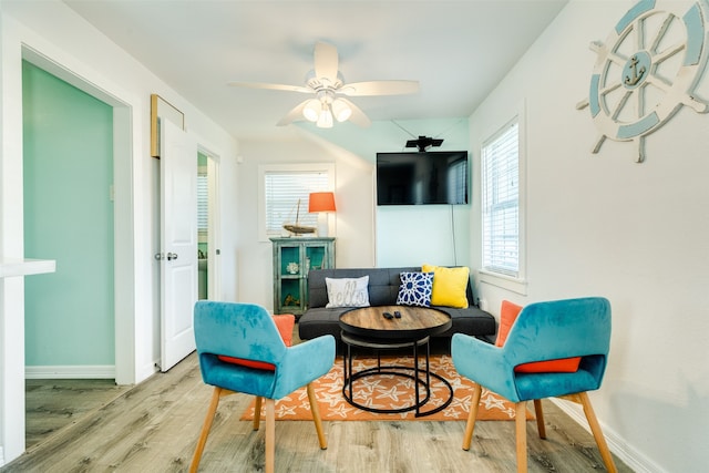 sitting room with ceiling fan and light hardwood / wood-style floors