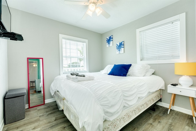 bedroom with ceiling fan and wood-type flooring