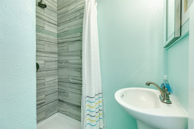 bathroom with a shower with curtain and sink