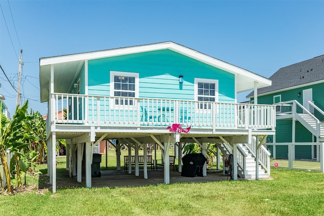 rear view of property featuring a lawn and a patio