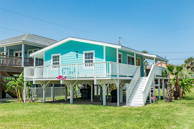 back of property featuring a wooden deck and a lawn