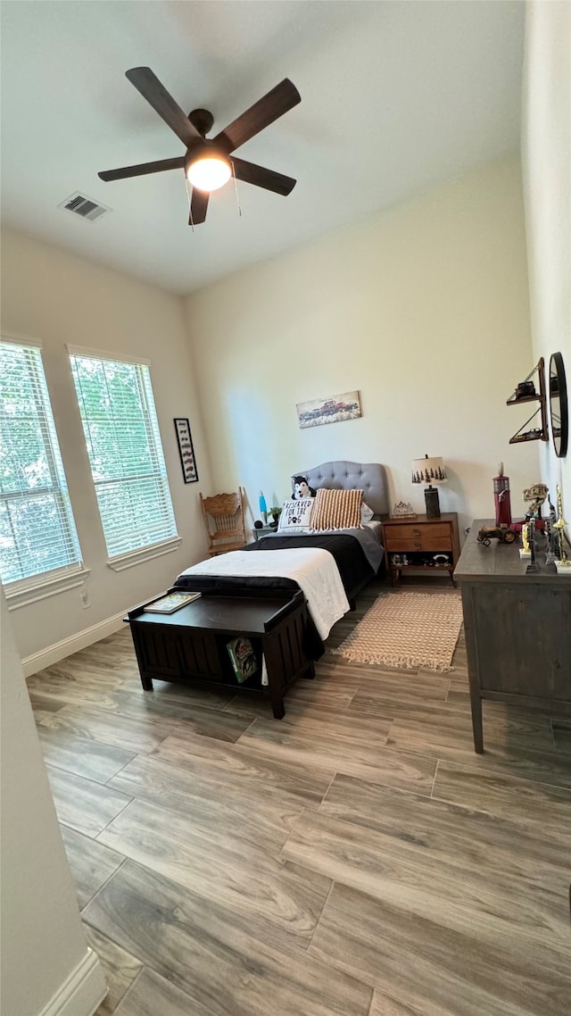 bedroom with hardwood / wood-style floors and ceiling fan