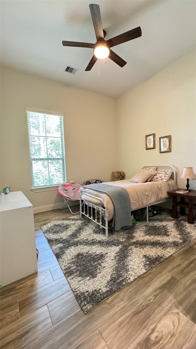 bedroom with ceiling fan and hardwood / wood-style floors