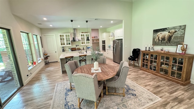 dining area with sink and light hardwood / wood-style floors