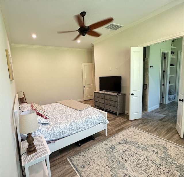 bedroom with ornamental molding, dark hardwood / wood-style flooring, and ceiling fan