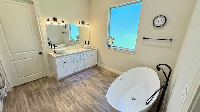 bathroom featuring a bathtub, wood-type flooring, and vanity