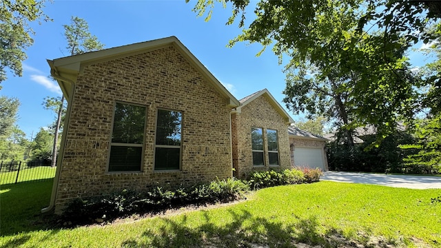 view of front of house featuring a garage and a front lawn