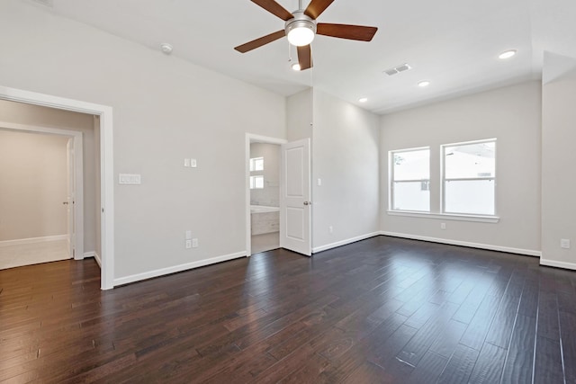 spare room with ceiling fan and dark wood-type flooring