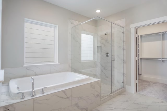 bathroom with separate shower and tub and a healthy amount of sunlight