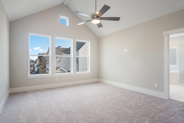 carpeted empty room with high vaulted ceiling and ceiling fan