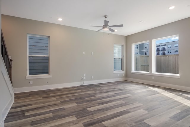 spare room with ceiling fan and dark wood-type flooring