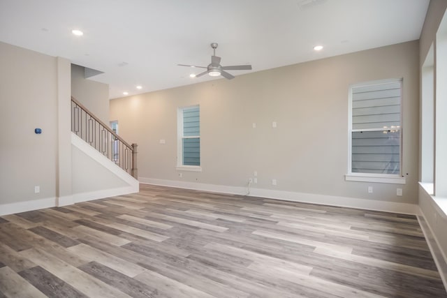 spare room with ceiling fan and light wood-type flooring