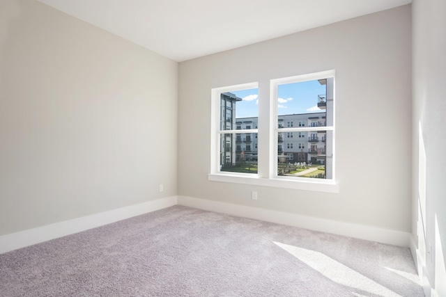 unfurnished bedroom with light colored carpet and a closet