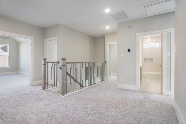 hallway featuring light carpet