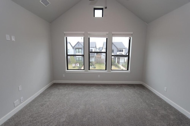 empty room with a healthy amount of sunlight, carpet floors, and high vaulted ceiling