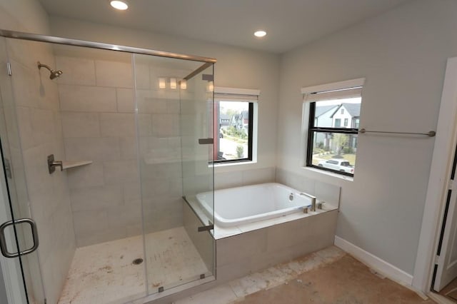 bathroom featuring shower with separate bathtub