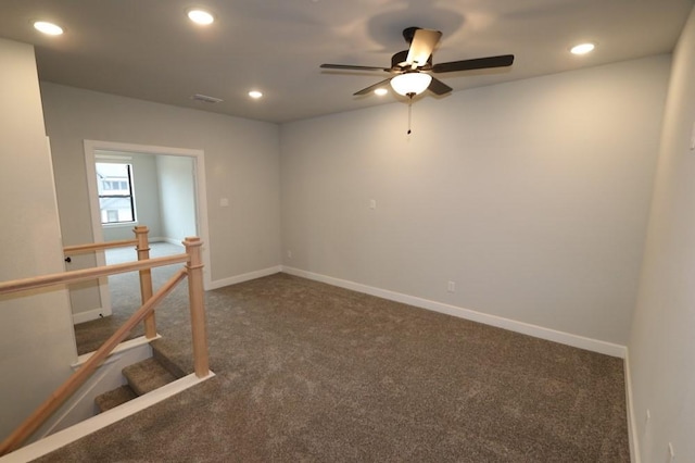 carpeted spare room featuring ceiling fan