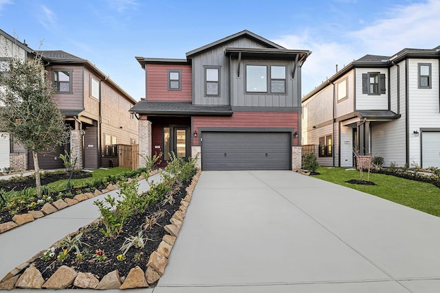 view of front facade with a garage, brick siding, concrete driveway, board and batten siding, and a front yard