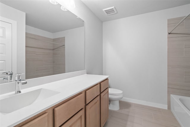 full bathroom with vanity, toilet, and tiled shower / bath