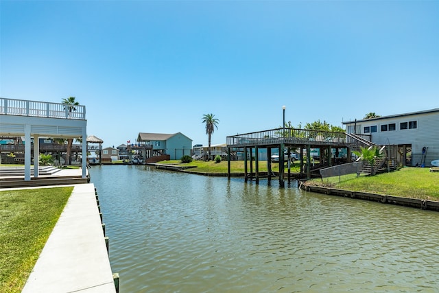 dock area featuring a lawn and a water view