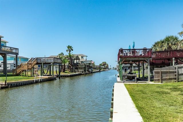 view of dock featuring a yard and a deck with water view