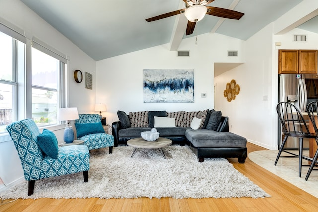 living room featuring ceiling fan, vaulted ceiling with beams, and light hardwood / wood-style flooring