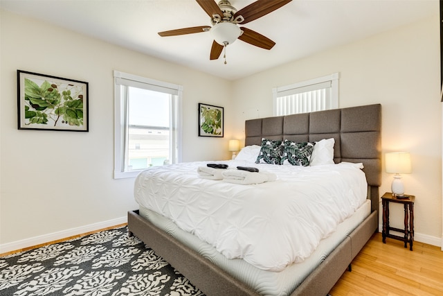 bedroom with ceiling fan and light hardwood / wood-style floors