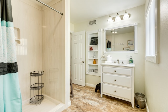 bathroom featuring a shower with shower curtain and vanity