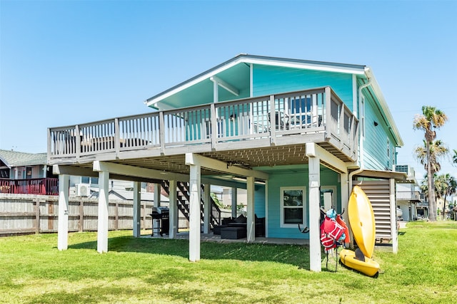 back of property featuring a lawn and a wooden deck