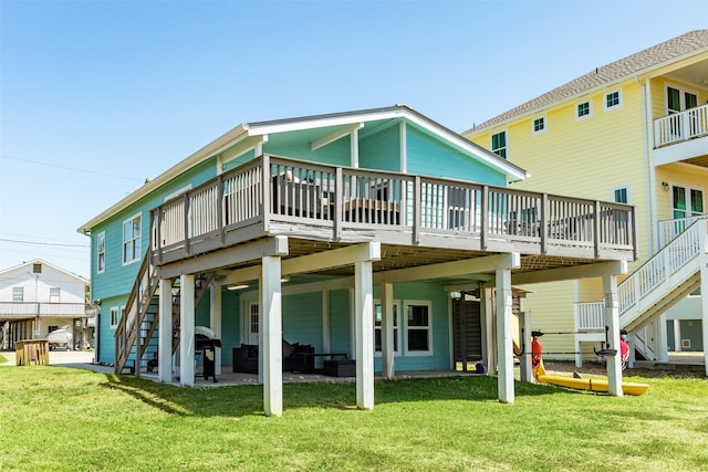 back of property with a lawn, a patio area, and a deck