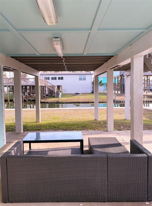 view of patio with a water view and outdoor lounge area