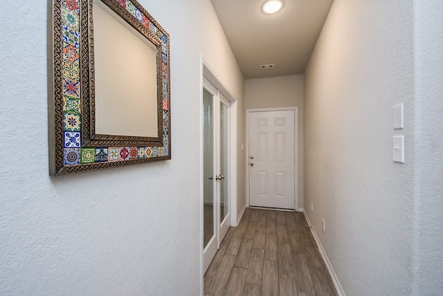 corridor featuring wood-type flooring